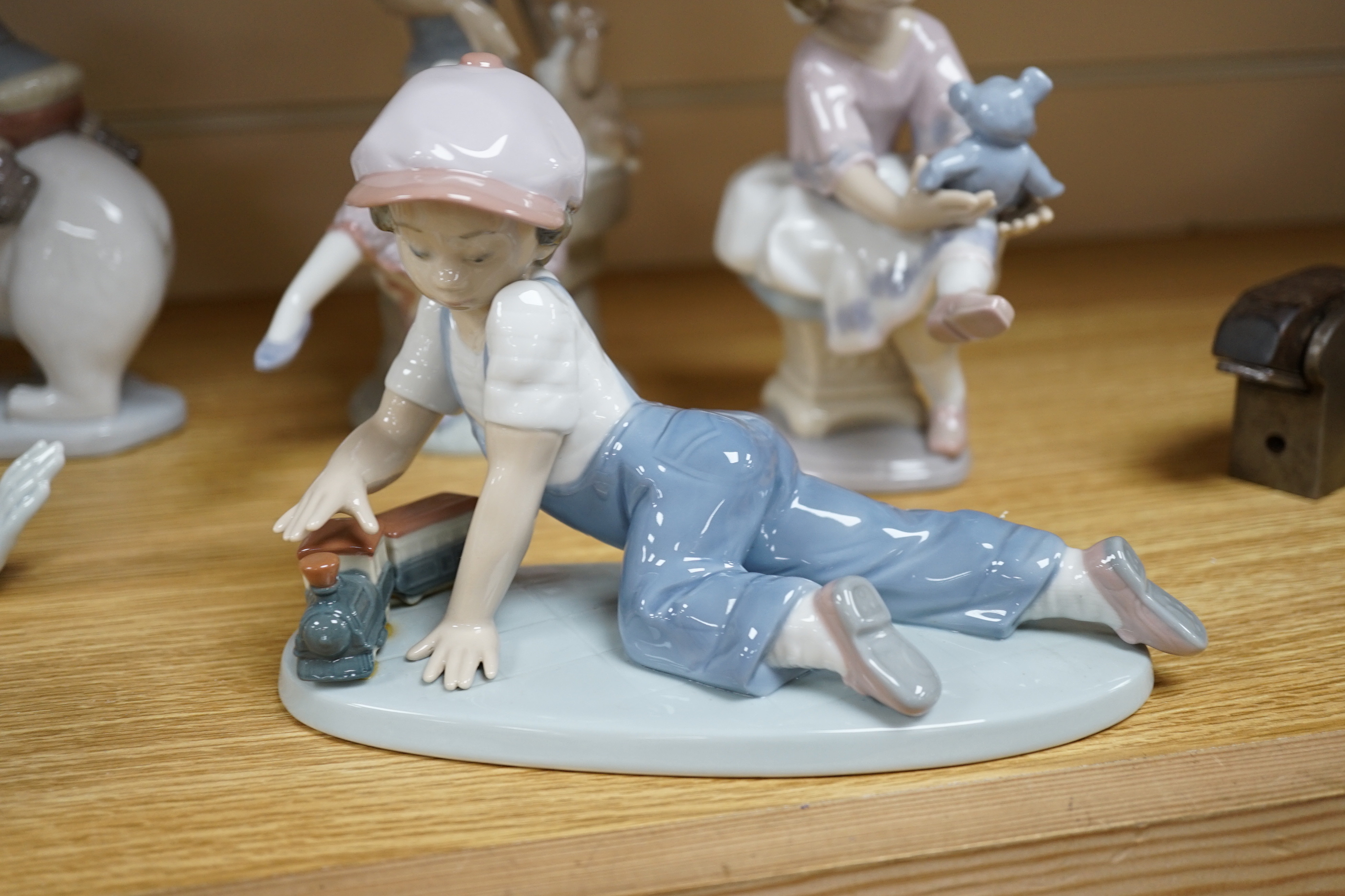 Seven Lladro figures including a clown together with three Lladro bells, the clown 37cm wide